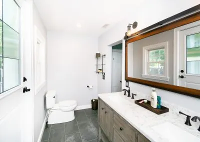 Welland Road Brookline primary bath with walnut vanity and a curbless walk-in shower