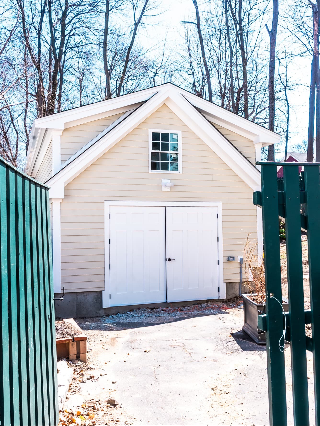 Powder House Rd. Ext Medford detached garage addition with cream siding, white trim, paneled double doors
