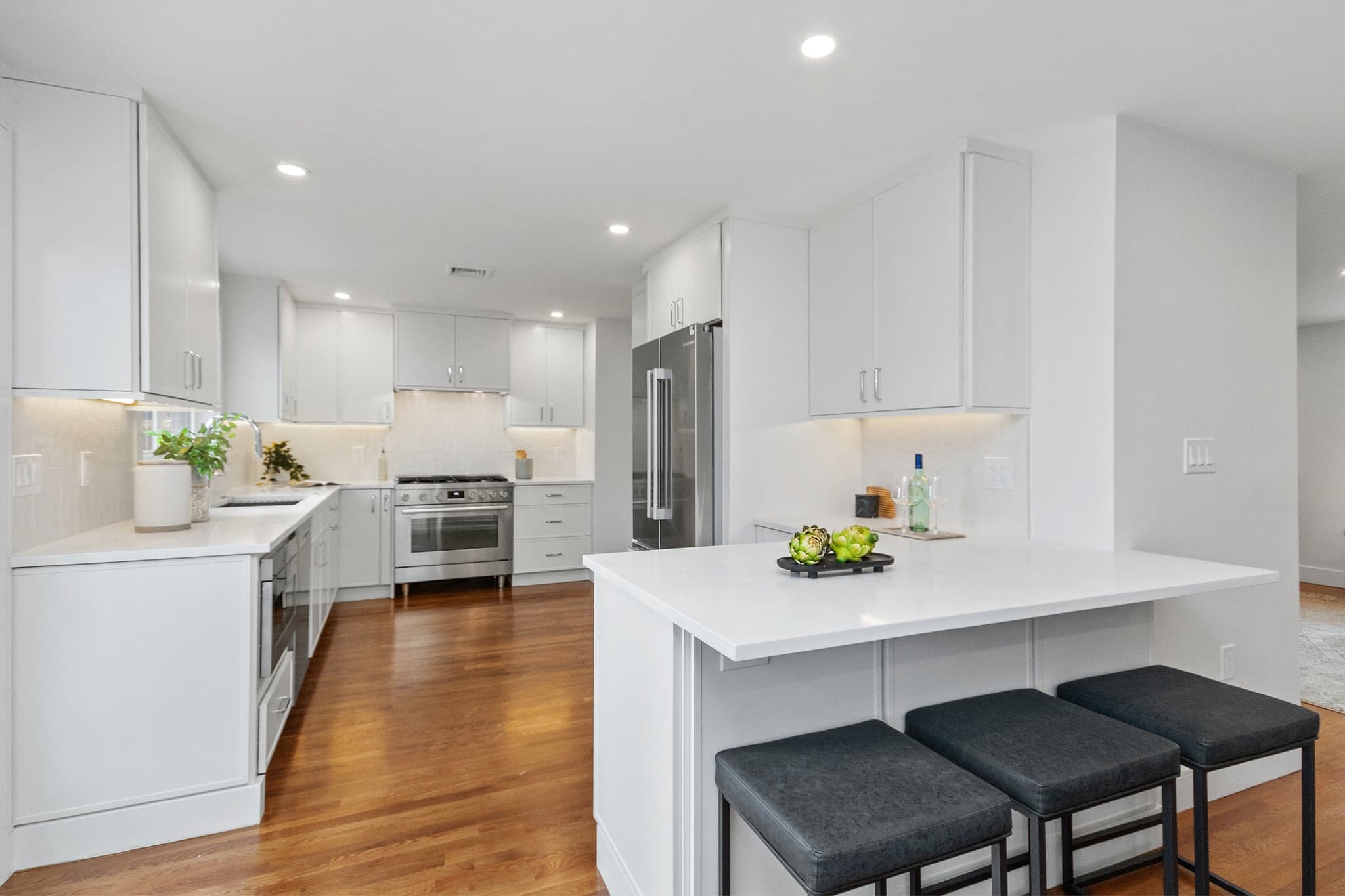 Windermere Rd. Newton whole-home remodel with white kitchen cabinets, stainless appliances and a dark hardwood floor