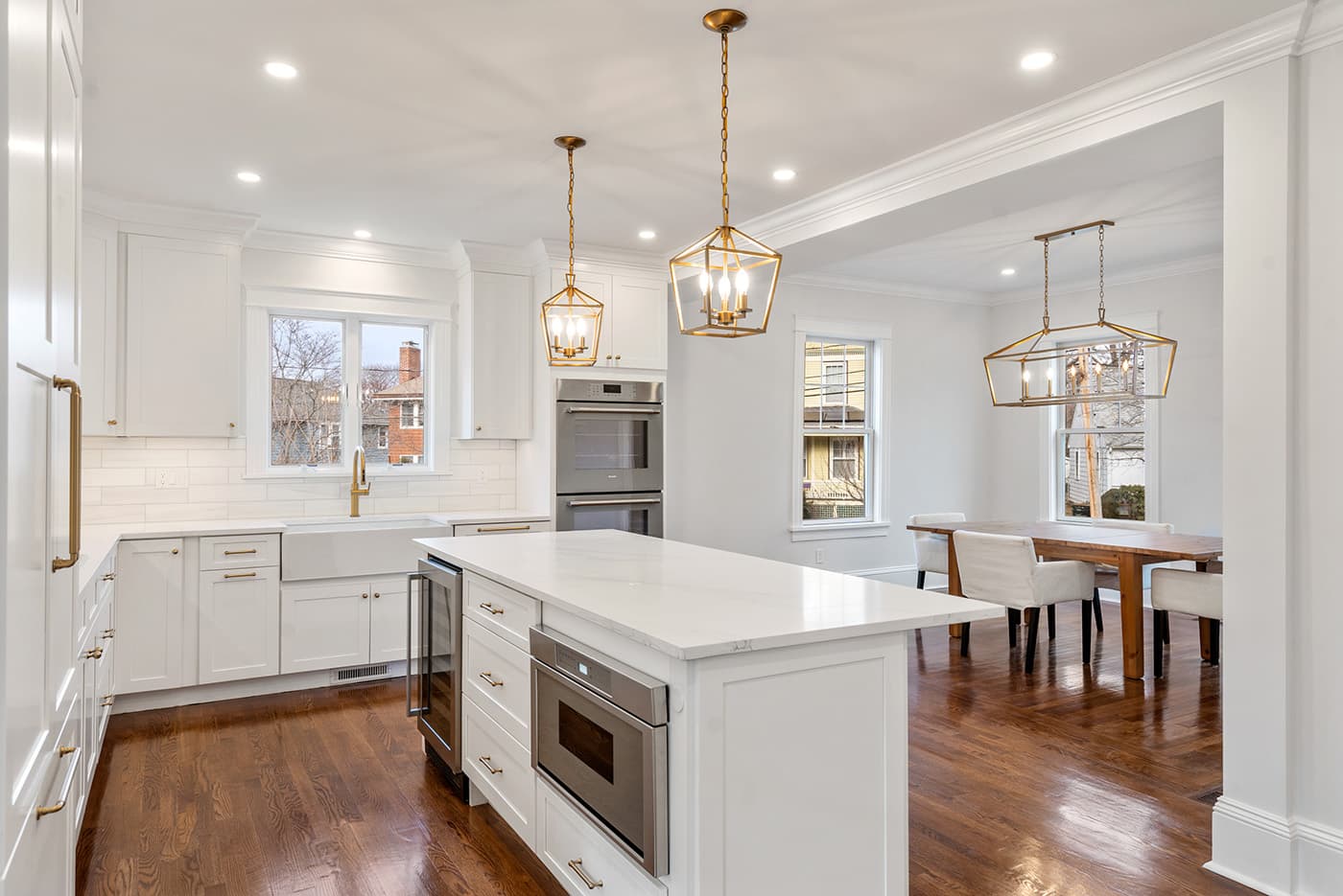 Auburndale Ave. Newton kitchen with white cabinets, brass hardware, marble counters, and farmhouse sink