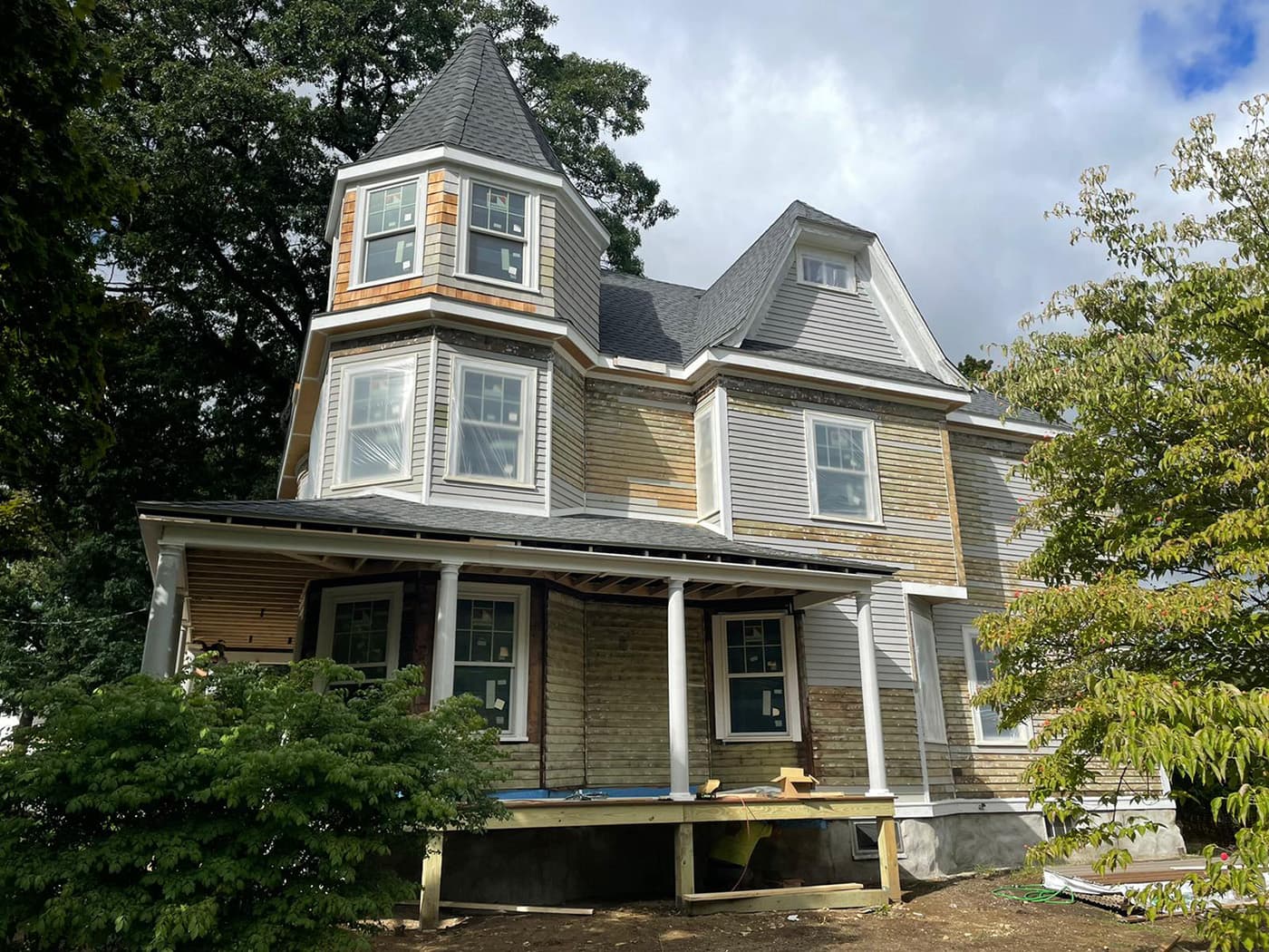 Auburndale Ave. Newton whole-home remodel mid-construction with exposed sheathing on a turreted Victorian home