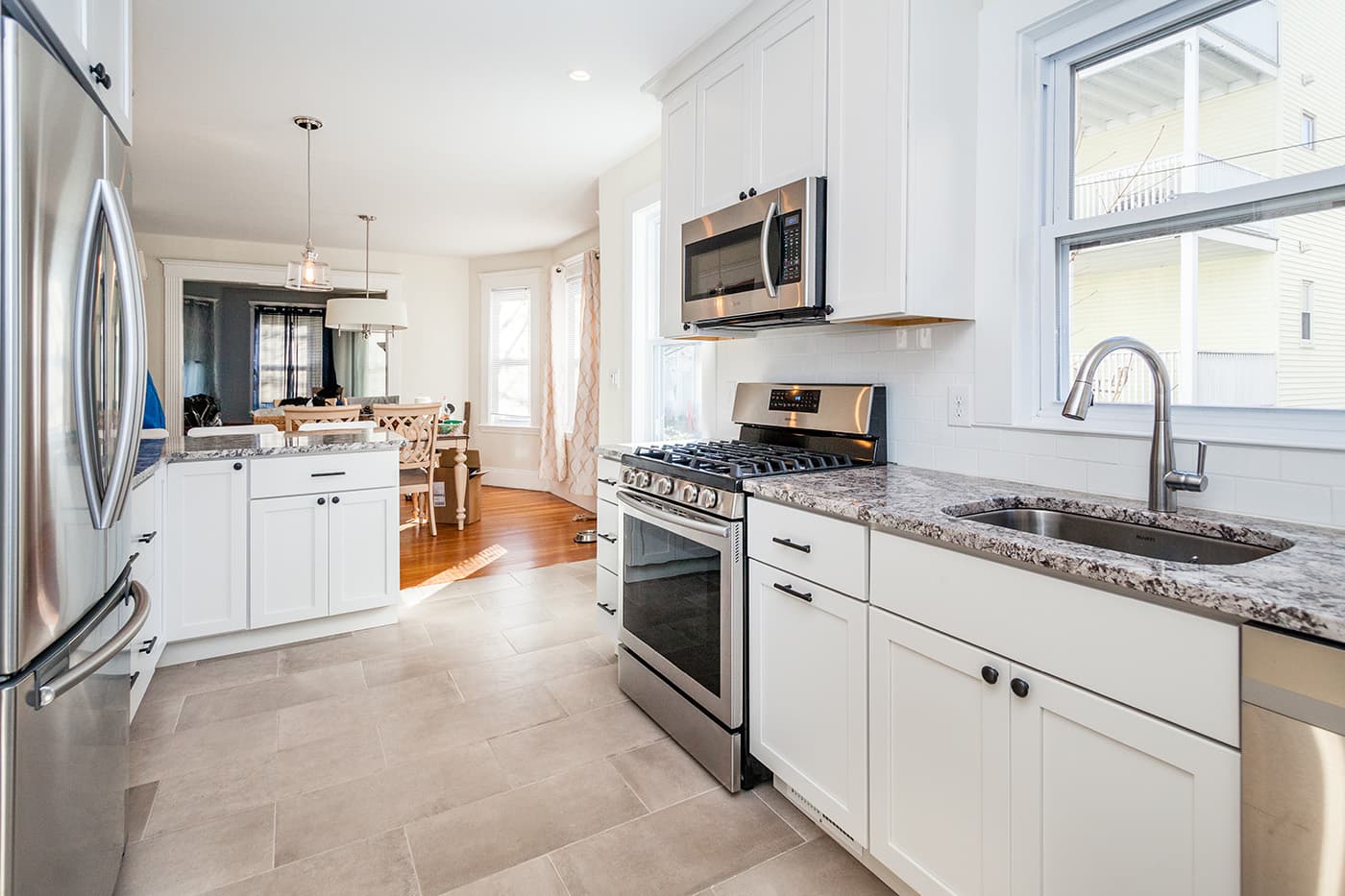 Brattle St. Arlington kitchen with white cabinets, granite counters, and subway-tile backsplash