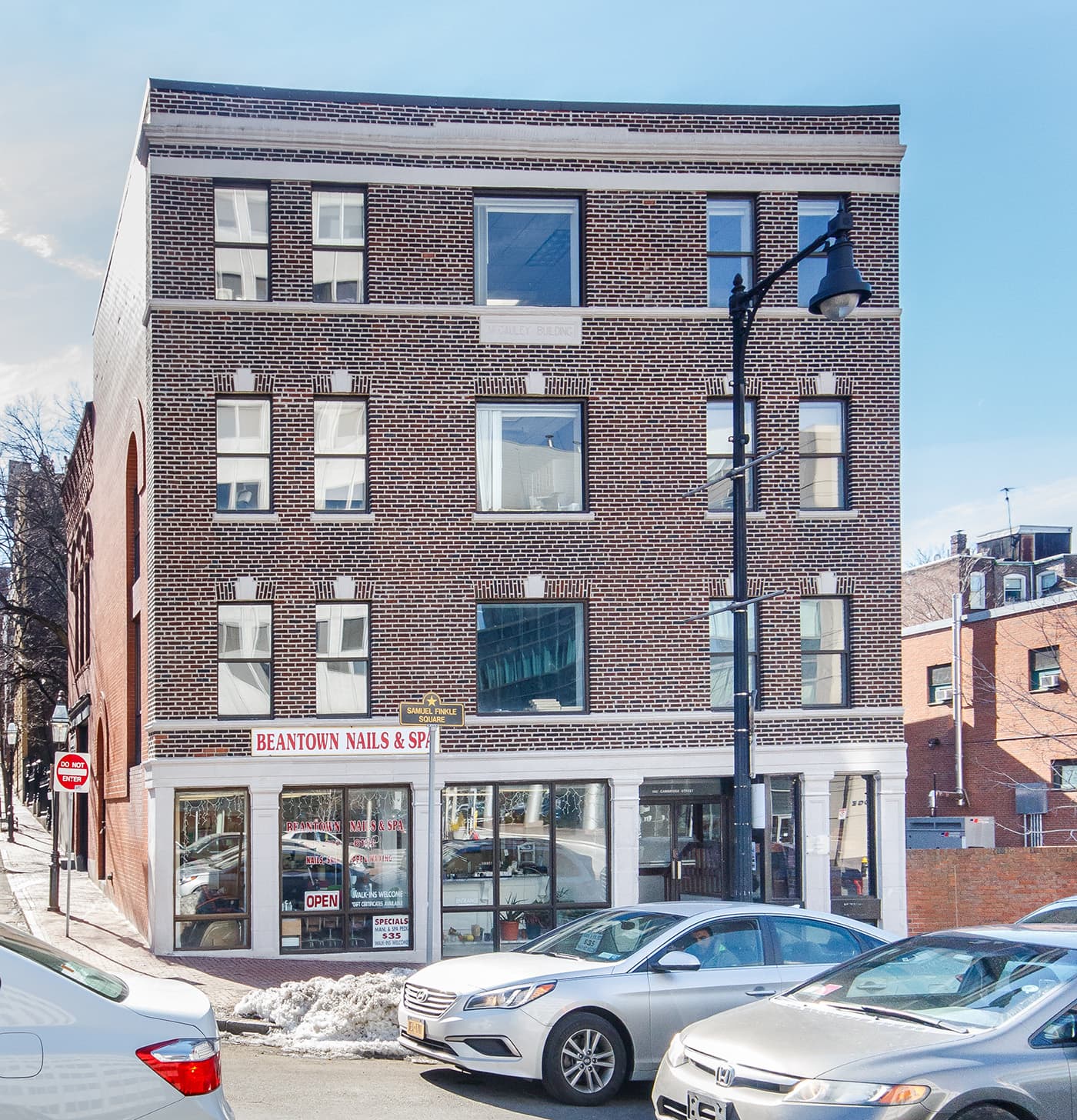 Cambridge St. Boston renovated brick building with arched windows and ground-floor nail salon storefront