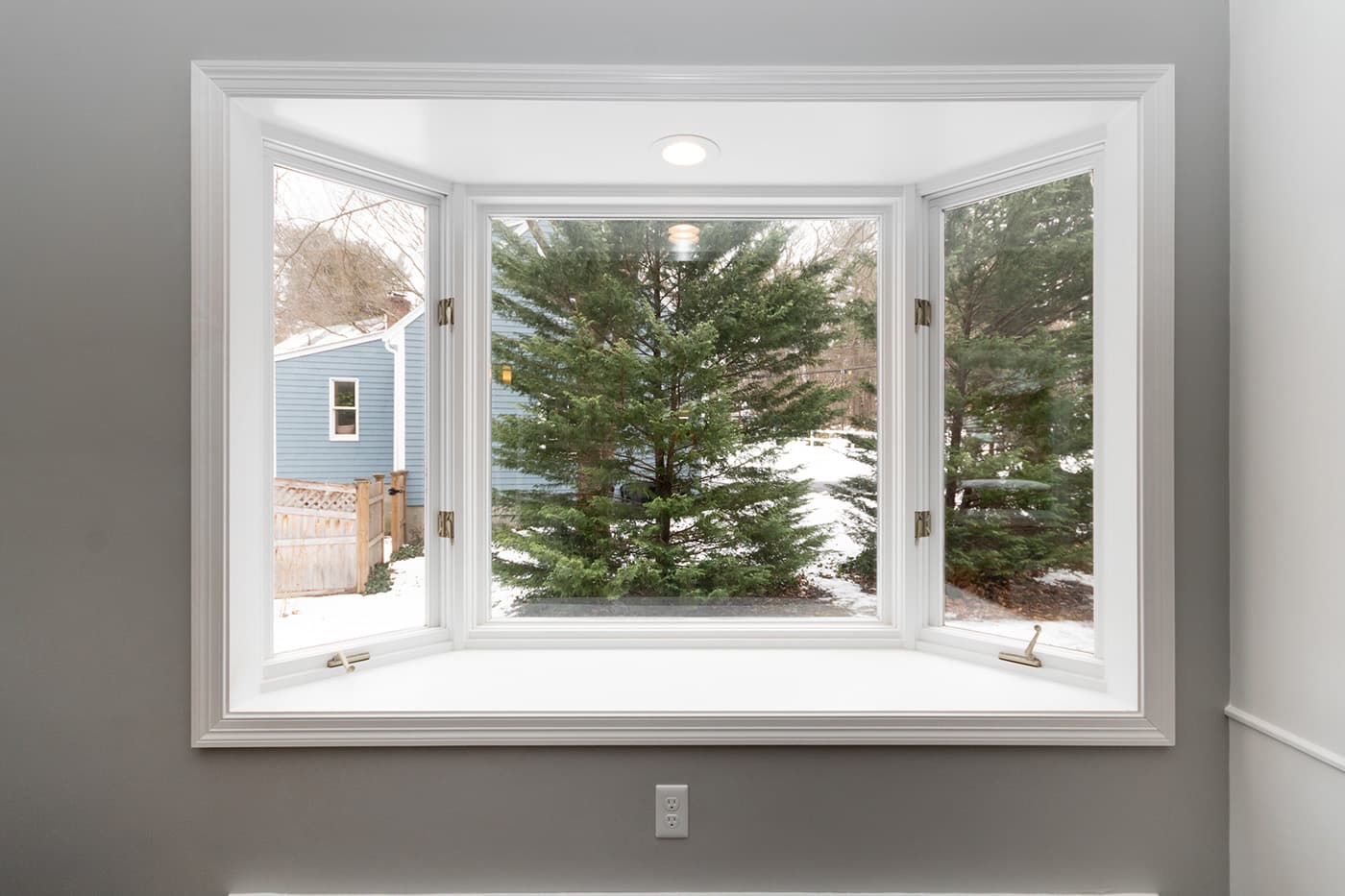 Renovated Columbine Rd. Milton living room, close-up of the white bay window seat beside the staircase