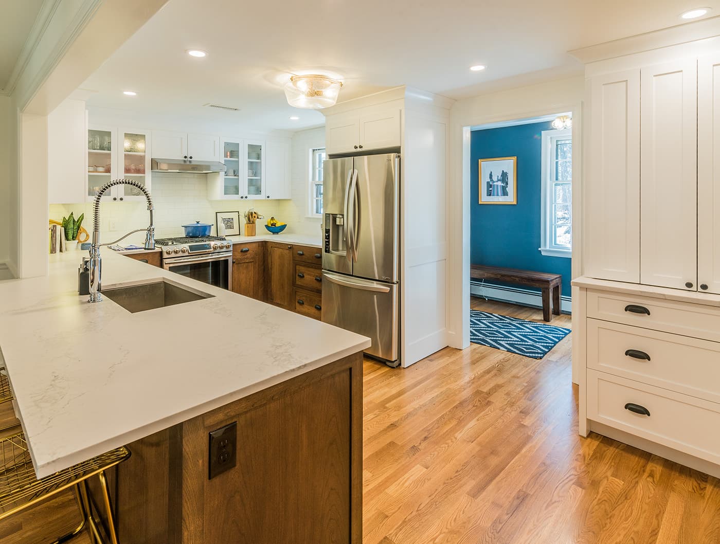 Draper Rd. Wayland kitchen with white cabinets, walnut island base, and white quartz counters