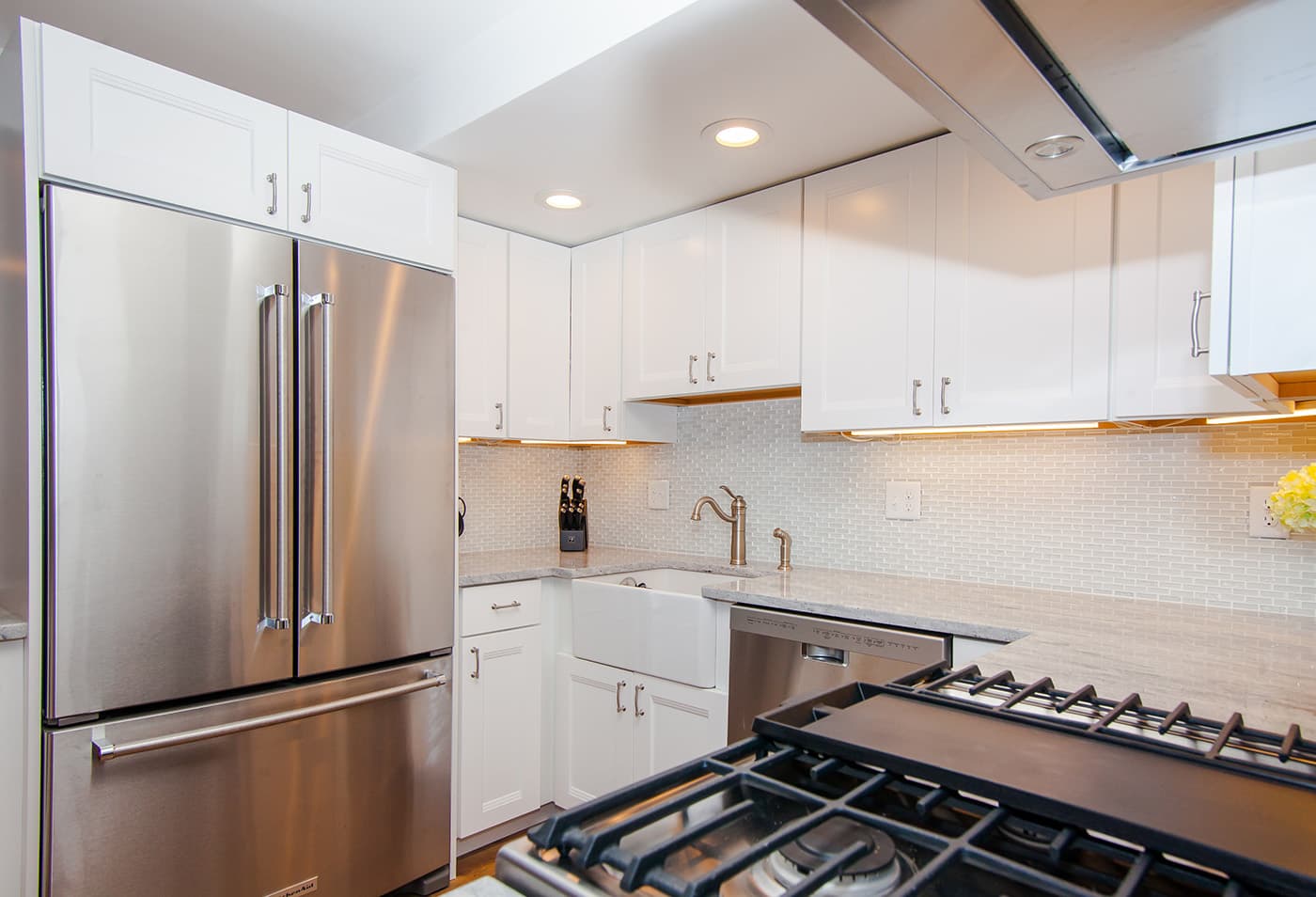 Ellery St. Cambridge kitchen with white cabinets, mosaic tile backsplash, and speckled quartz countertops