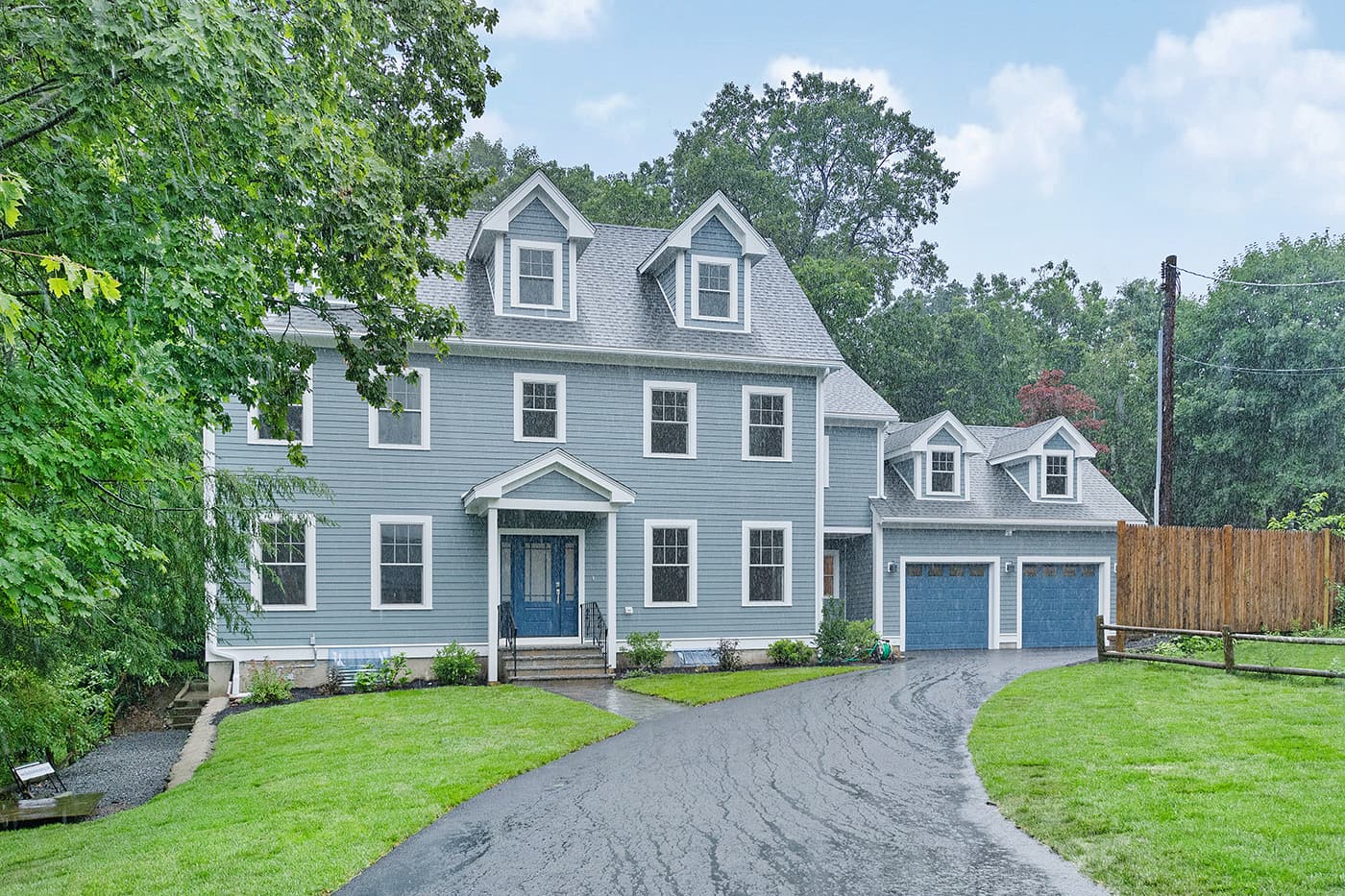 Garland Rd. Newton whole-home remodel with blue-gray siding, white trim and an attached two-car garage