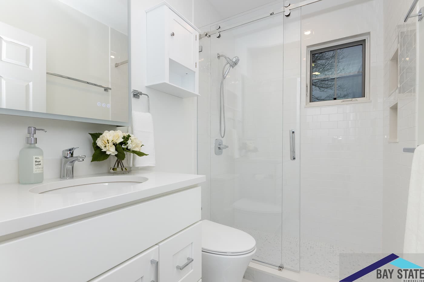 Renovated Harvey St. Cambridge bathroom with white subway tile shower and sliding glass door