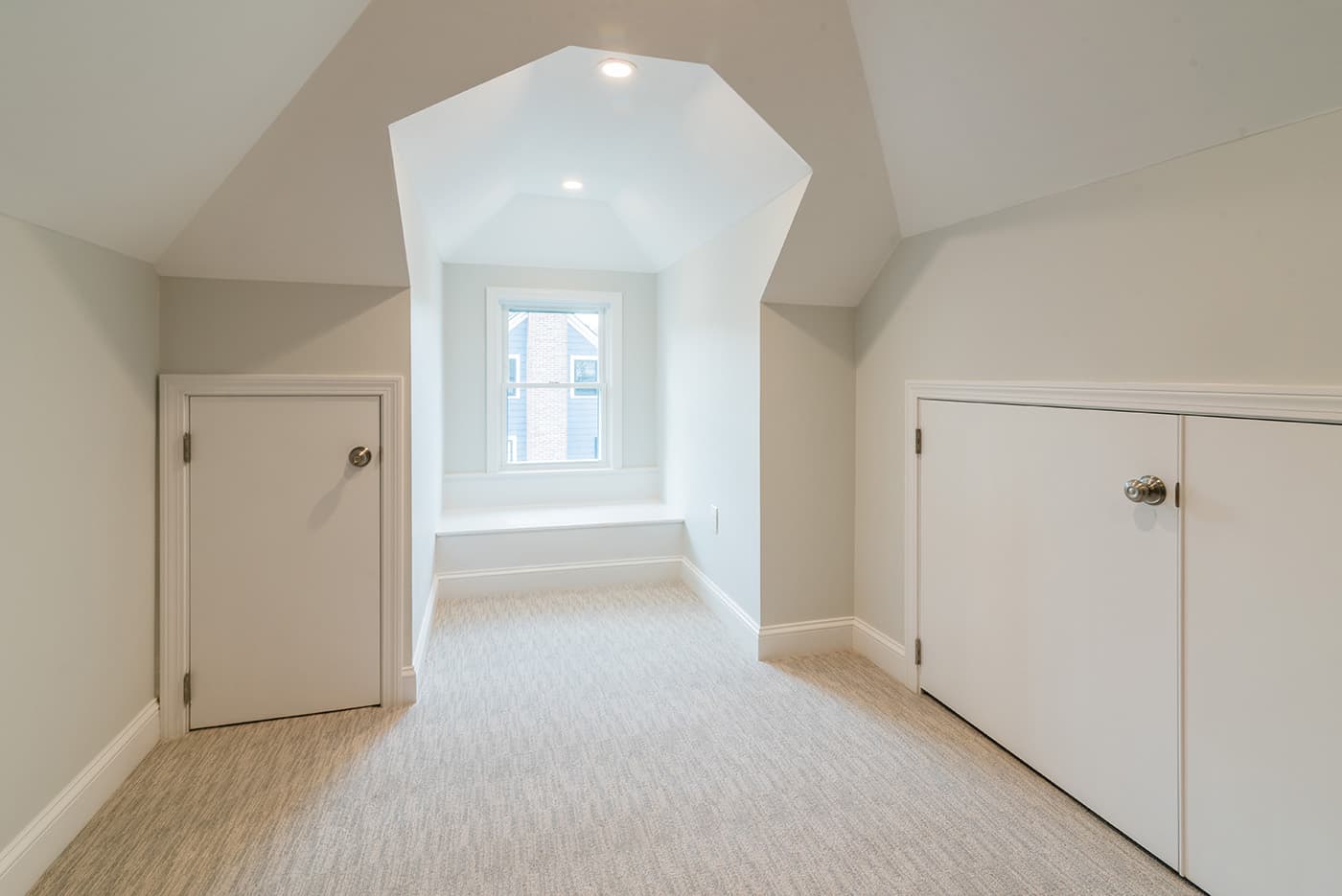 Finished attic on Madison St. in Belmont with a dormer window seat and built-in closets under the eaves