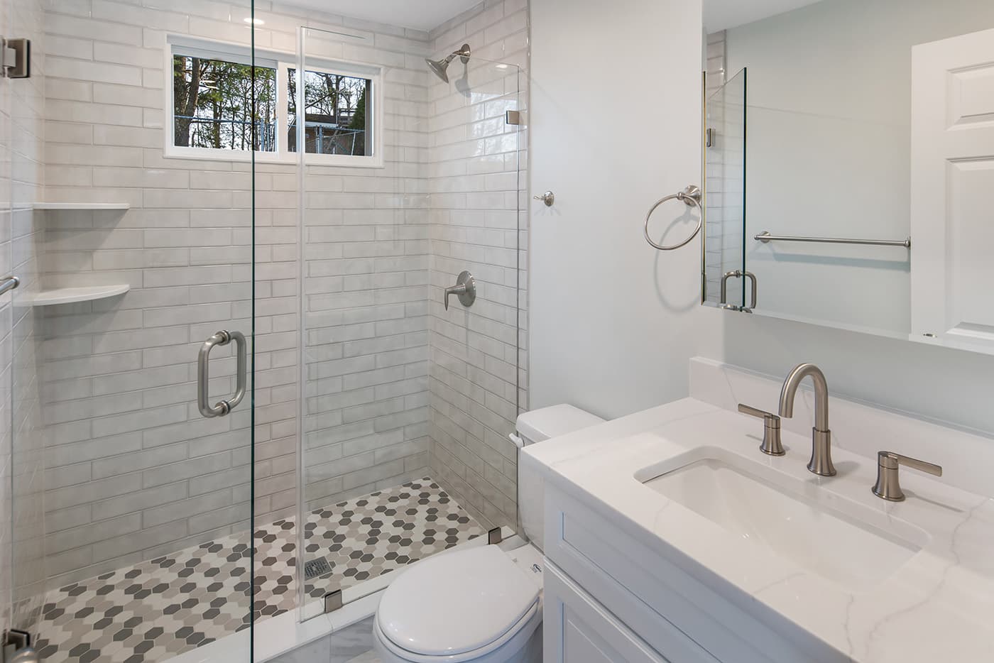 Renovated Mount Vernon Ave. Waltham bathroom with white subway tile shower and gray hexagon floor tile