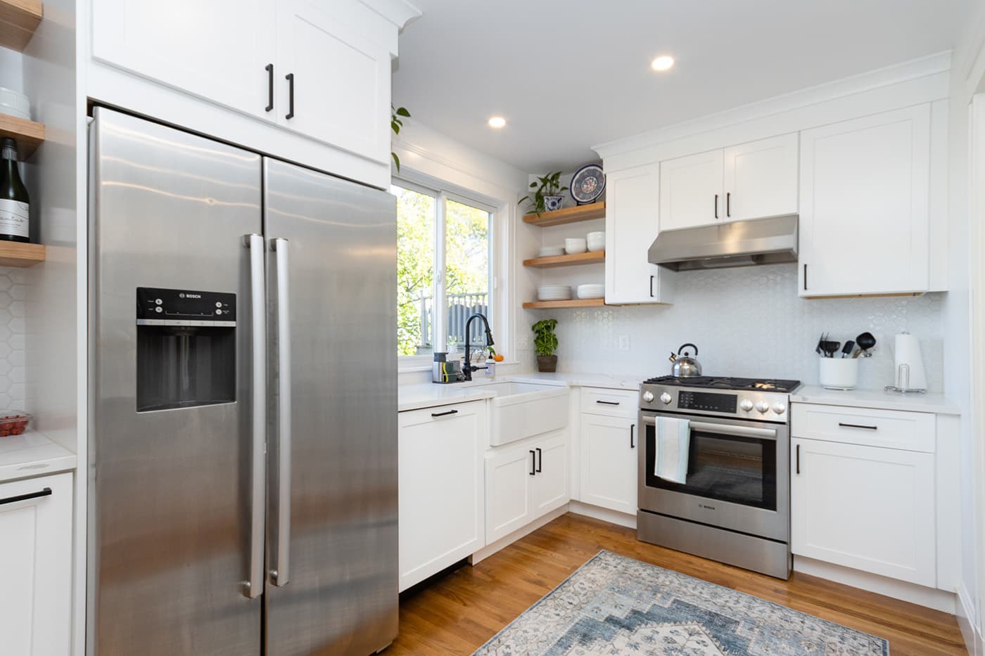 N Crescent Circuit Brighton kitchen with white cabinets, hexagon-tile backsplash, and open wood shelving