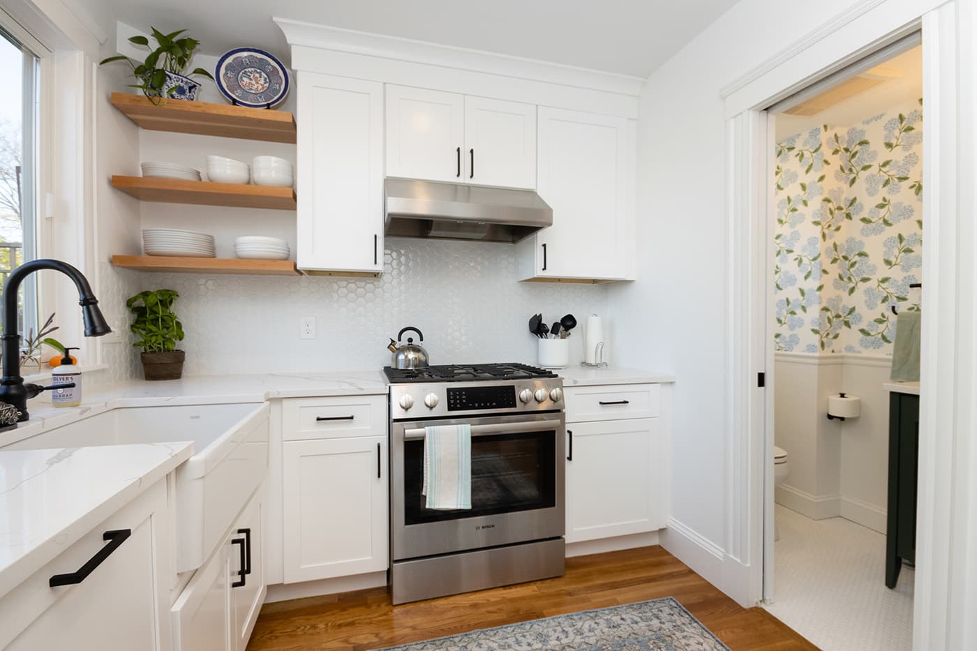 N Crescent Circuit Boston kitchen with white shaker cabinets, wood open shelving, and hex tile backsplash