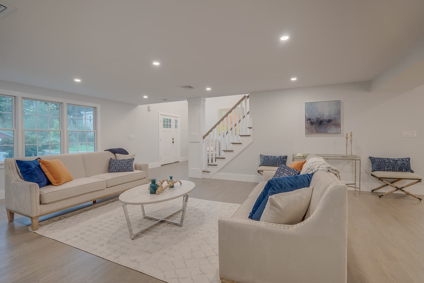 Potter St. Concord living room remodel with tall windows, a glass front door, dark wood floors