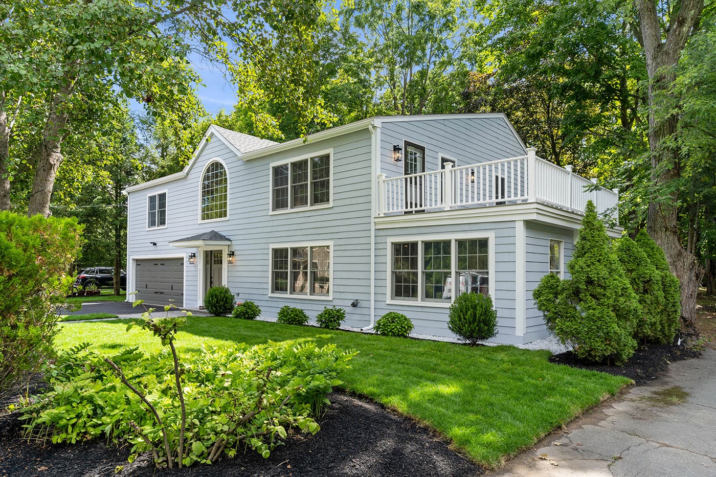Potter St. Concord whole-home remodel with blue-gray siding, an arched window and a second-floor deck