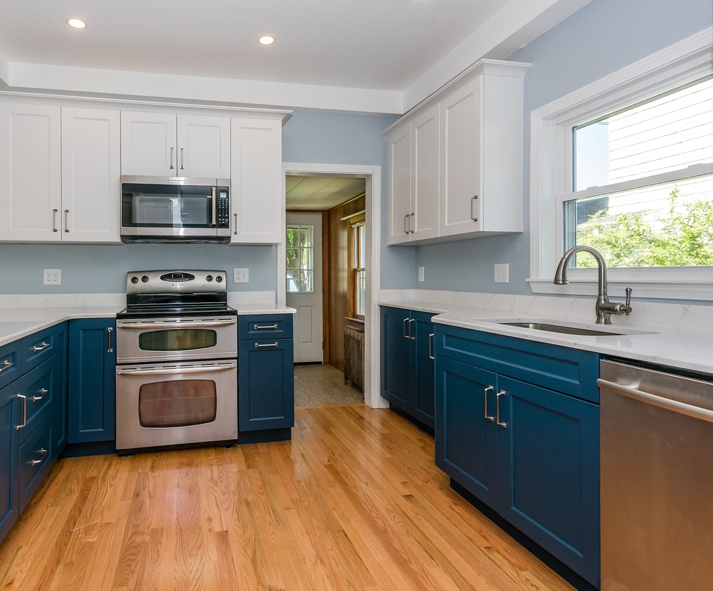 Sachem Rd. Dedham kitchen with navy lower cabinets, white upper cabinets, and quartz countertops