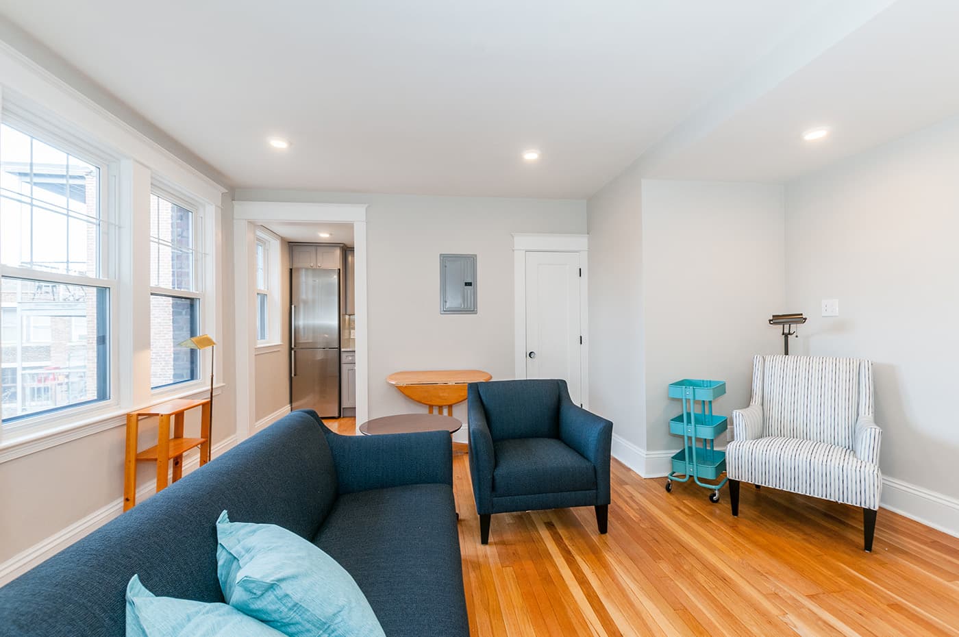 Sutherland Rd. Brighton whole-home remodel with an open living room, blue upholstered seating and wood flooring