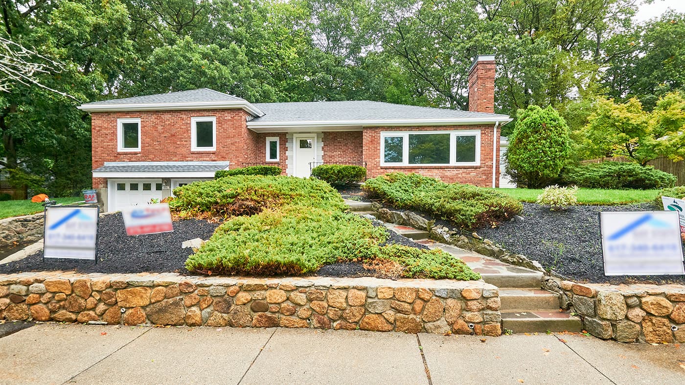 Walnut St. Newton whole-home remodel of a brick ranch with new landscaping and stone walls