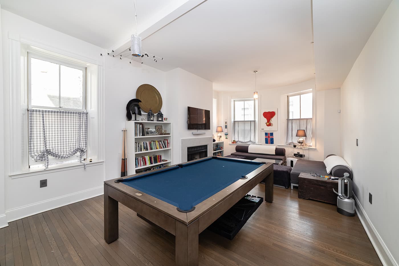 West Broadway Boston whole-home remodel with a game room, pool table, fireplace and bay window