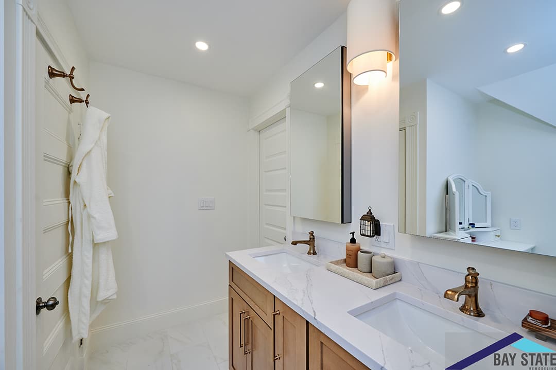 Renovated Morrill St. Dorchester bathroom with gray double vanity, backlit mirrors, and marble tile glass shower