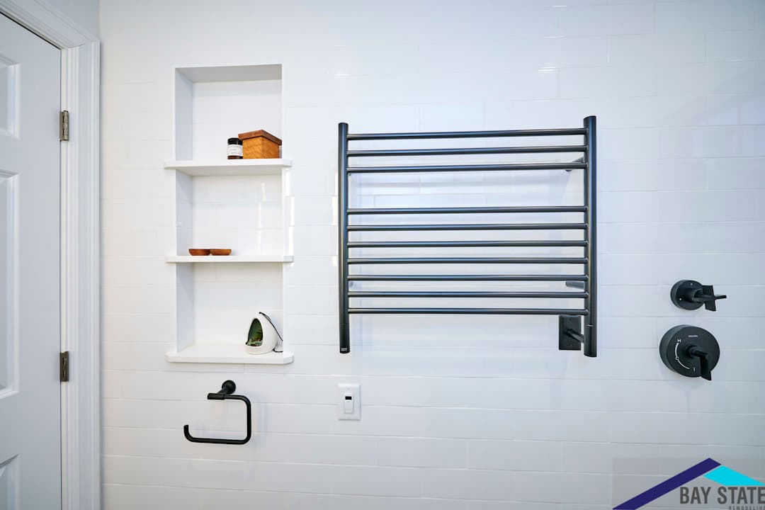 Renovated Harvey St. Cambridge bathroom, white subway tile, built-in shelf niche, black heated towel rack