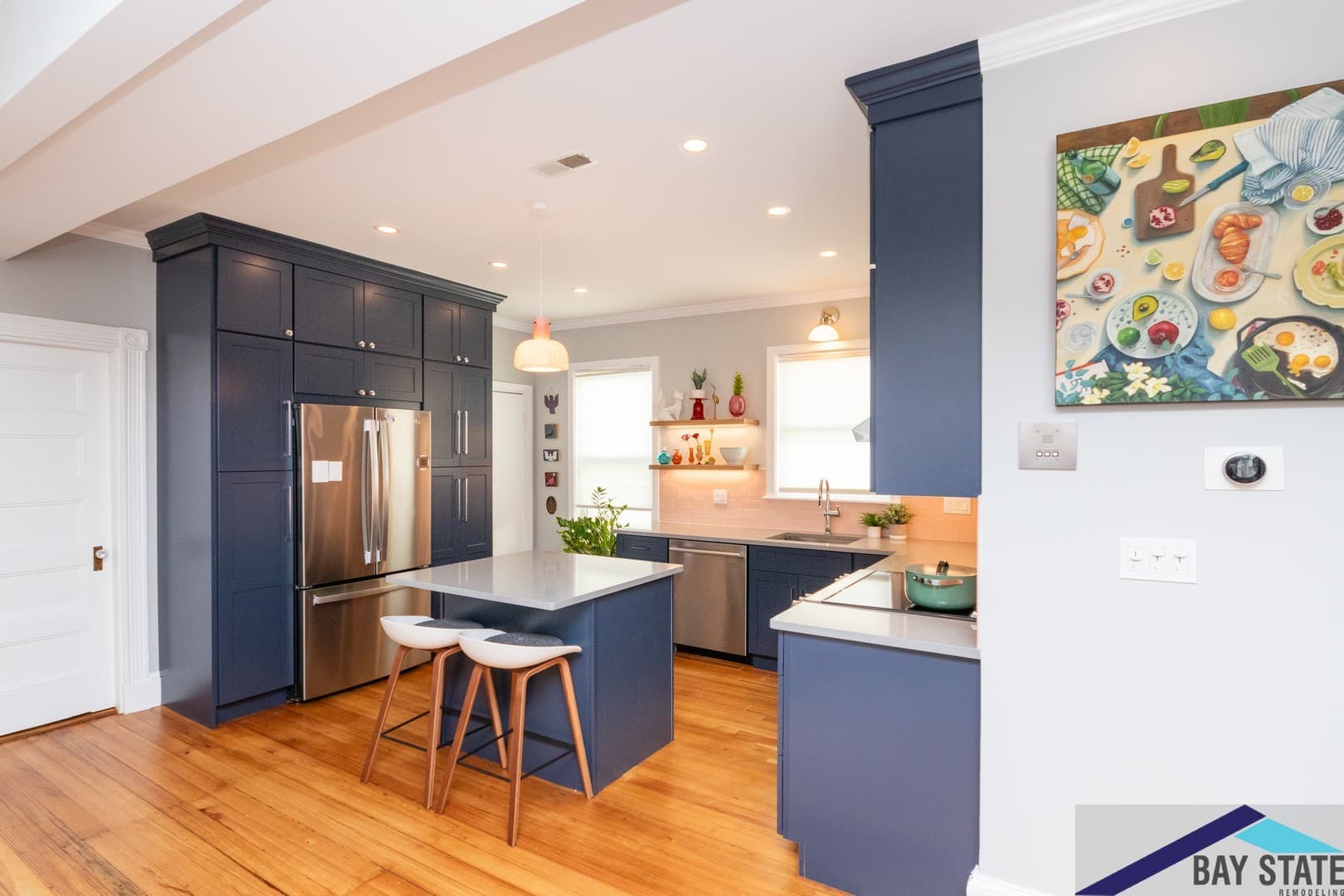 Dalrymple St. Jamaica Plain finished kitchen with navy cabinets, white quartz island, and pink tile backsplash