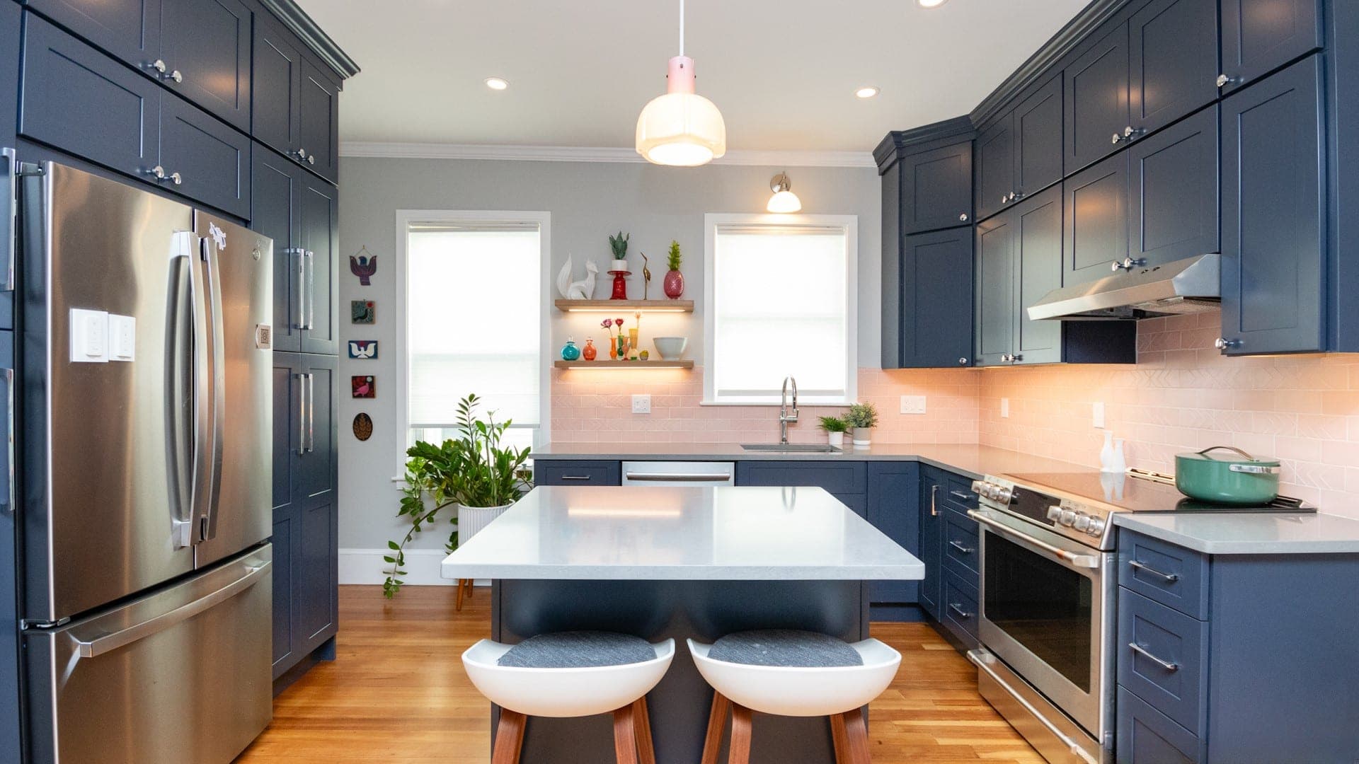 Dalrymple St. Jamaica Plain kitchen with navy cabinets, pink subway tile backsplash, and white quartz island