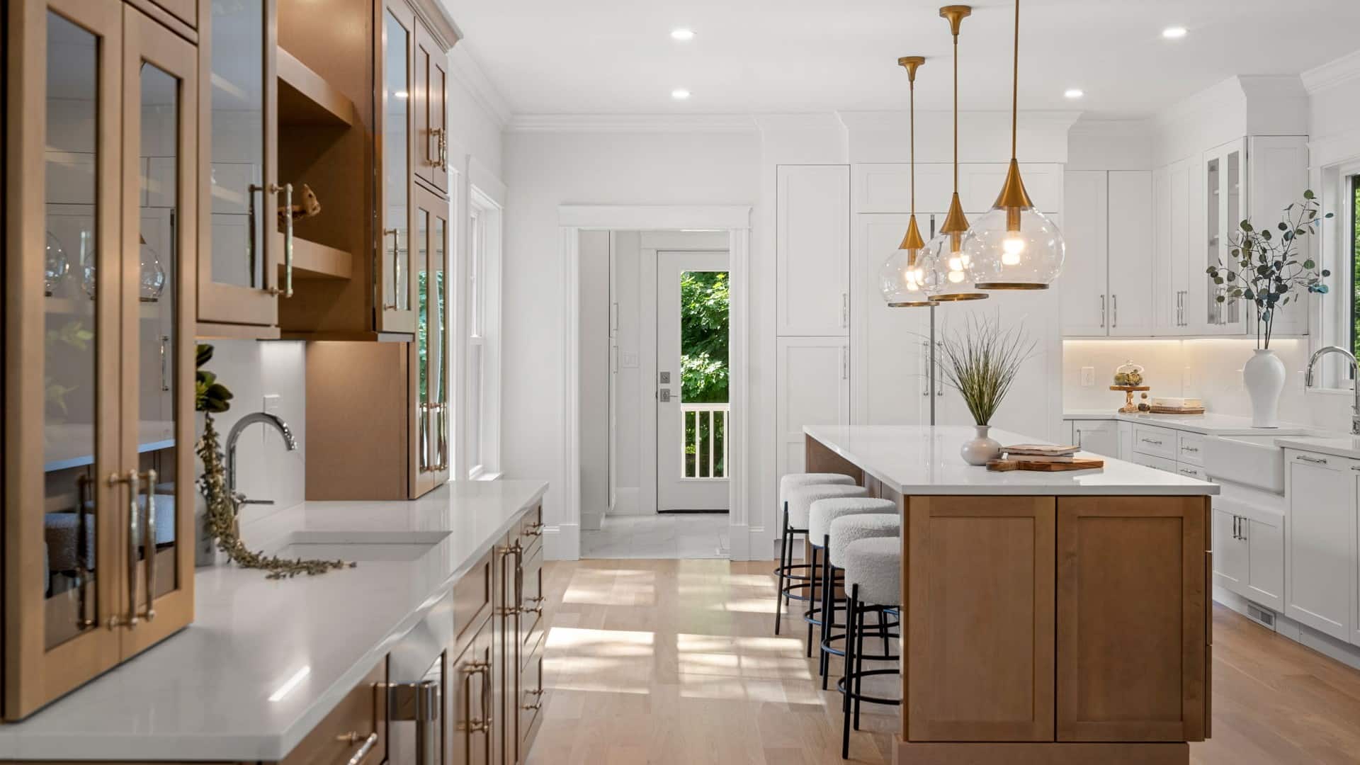 Sewall St. Newton kitchen with two-tone wood and white cabinets, brass pendants, and quartz island countertop