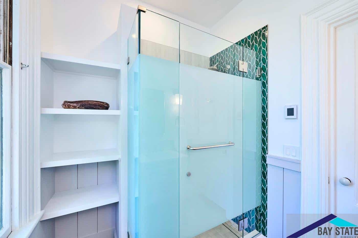 Remodeled Tennyson St. Somerville bathroom shower enclosure with frosted glass and built-in corner shelving nearby