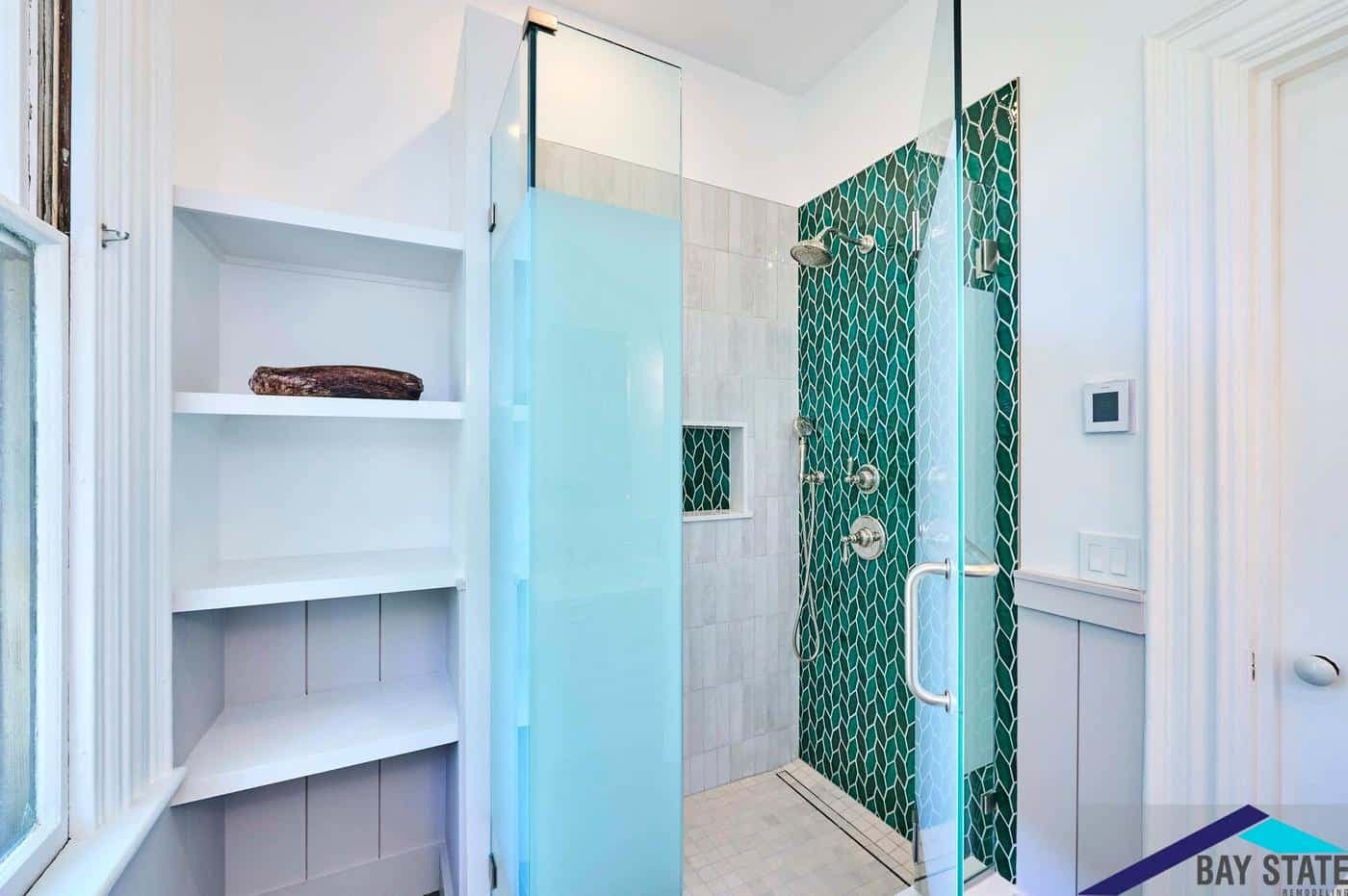 Somerville bathroom on Tennyson St. with green leaf-mosaic tile shower, glass door, and gray floor tile