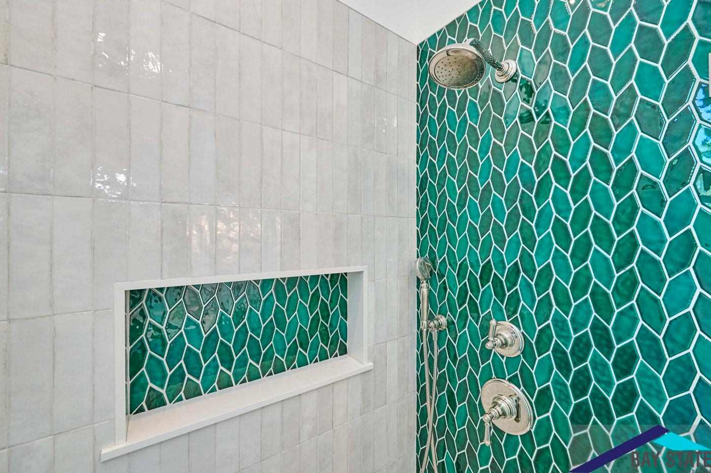Renovated Tennyson St. Somerville shower with emerald leaf-mosaic accent wall and built-in tile niche