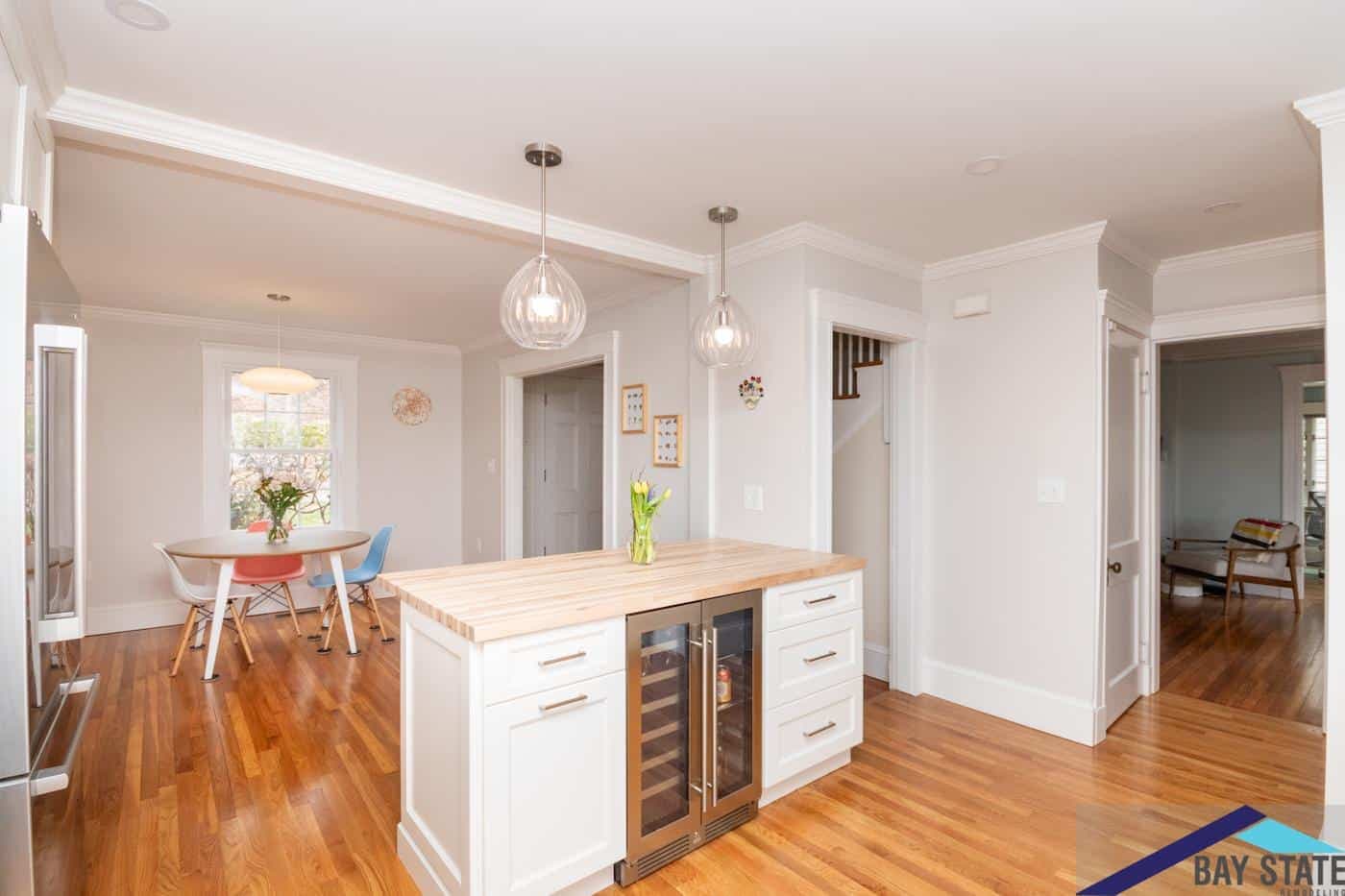 Renovated Newton kitchen on Trowbridge Ave. with butcher-block island, wine fridge, and dining nook