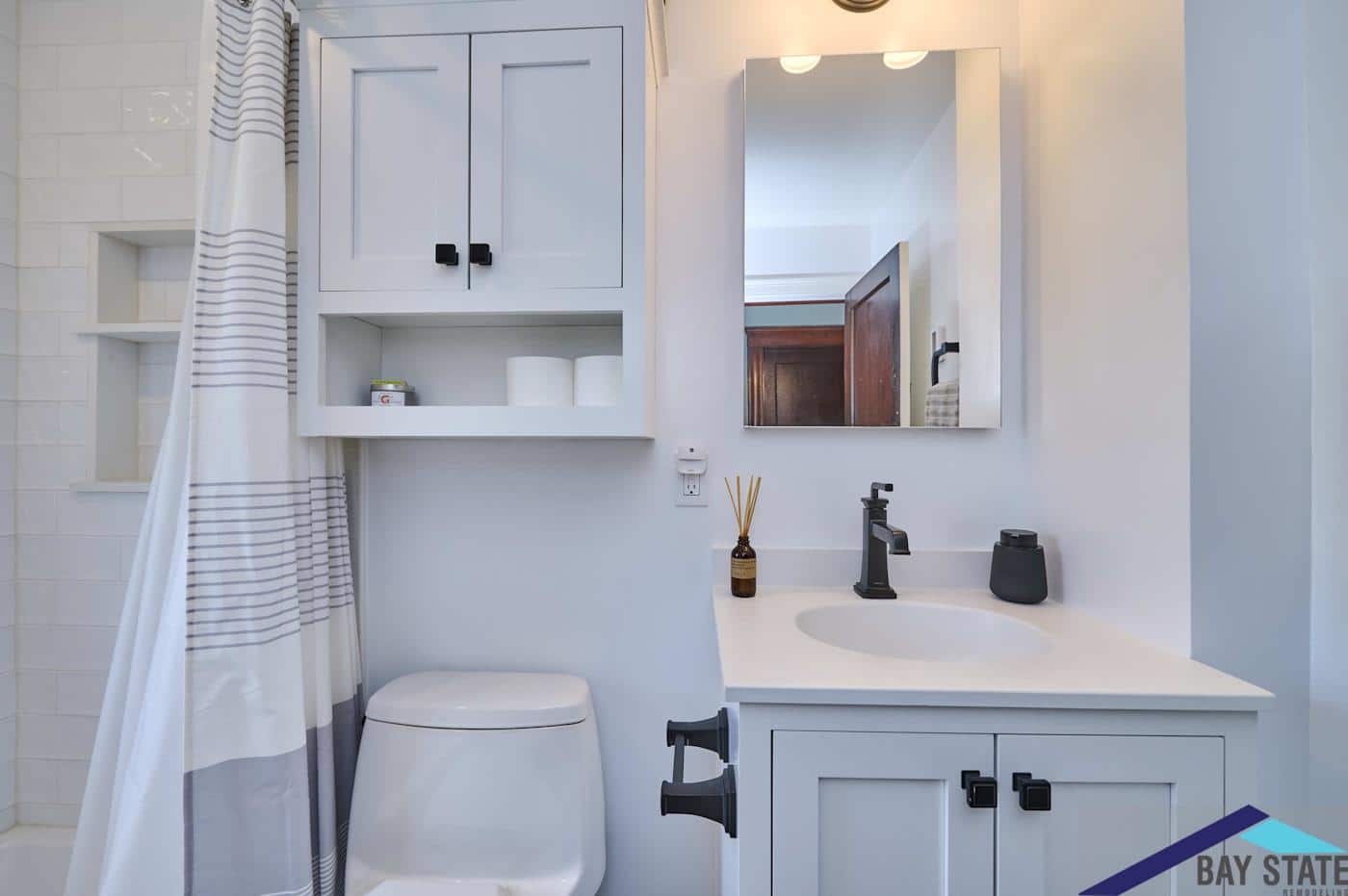 Remodeled N. Crescent Circuit Boston bathroom vanity with white shaker cabinet and matte black faucet