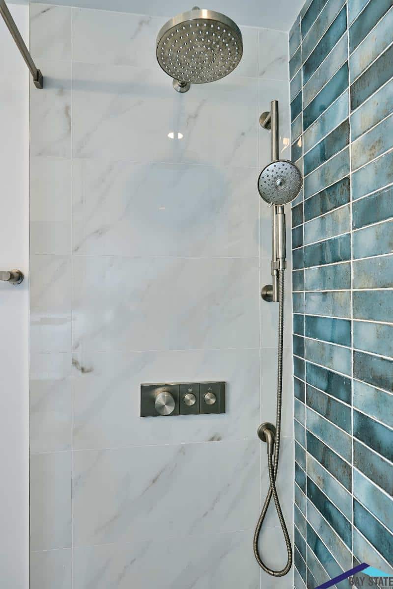 Renovated Newton bathroom on Kensington Ave. with walnut floating vanity and wall-mounted mirror