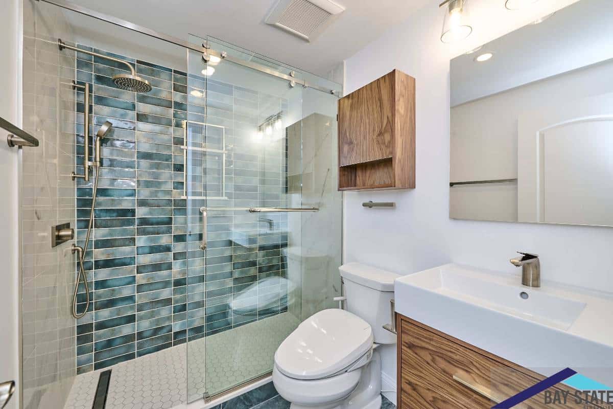 Kensington Ave. Newton bathroom vanity with three-light sconce and walnut wood cabinet