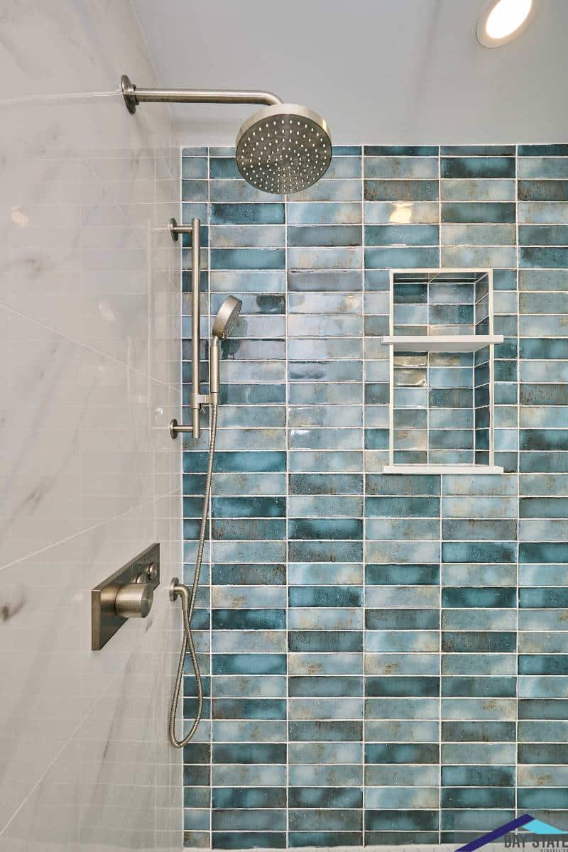 Newton bathroom on Kensington Ave. with walnut wall cabinet mounted beside glass shower