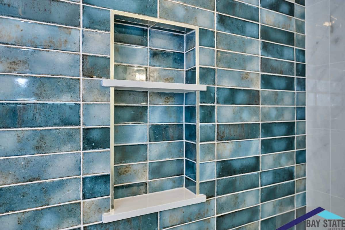 Renovated Kensington Ave. Newton bathroom with teal tile shower, glass door, and walnut vanity