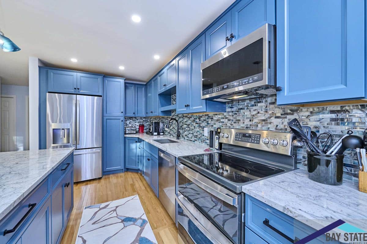 South Commons Lincoln kitchen with blue cabinets, mosaic backsplash, and marble countertops
