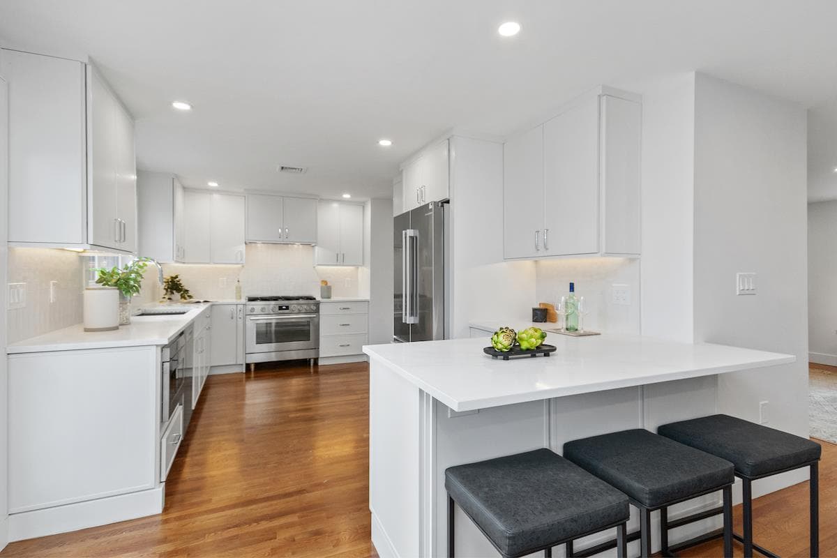 Windermere Rd. Newton whole-home remodel with white kitchen cabinets, stainless appliances and a dark hardwood floor