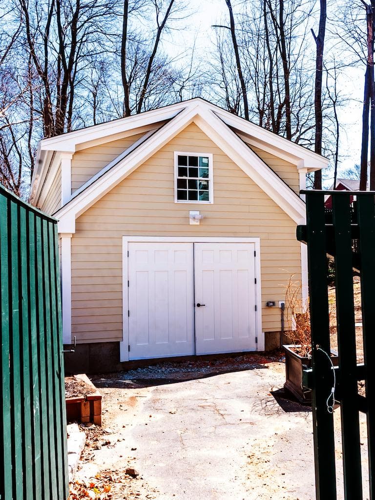 Powder House Rd. Ext Medford detached garage addition with cream siding, white trim, paneled double doors