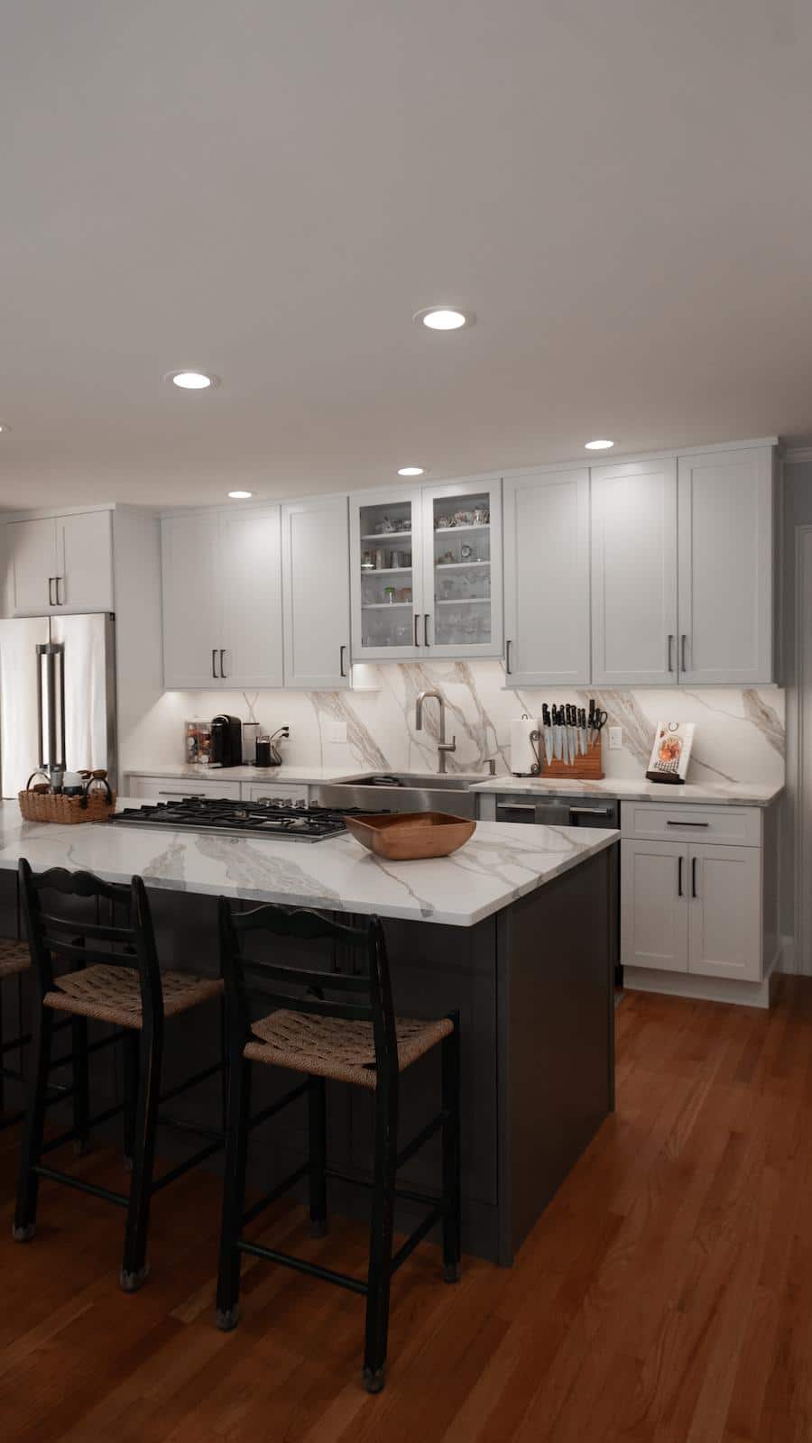 Wayland kitchen island on Brook Trail Rd. with gas cooktop, woven counter stools, and calacatta quartz countertop