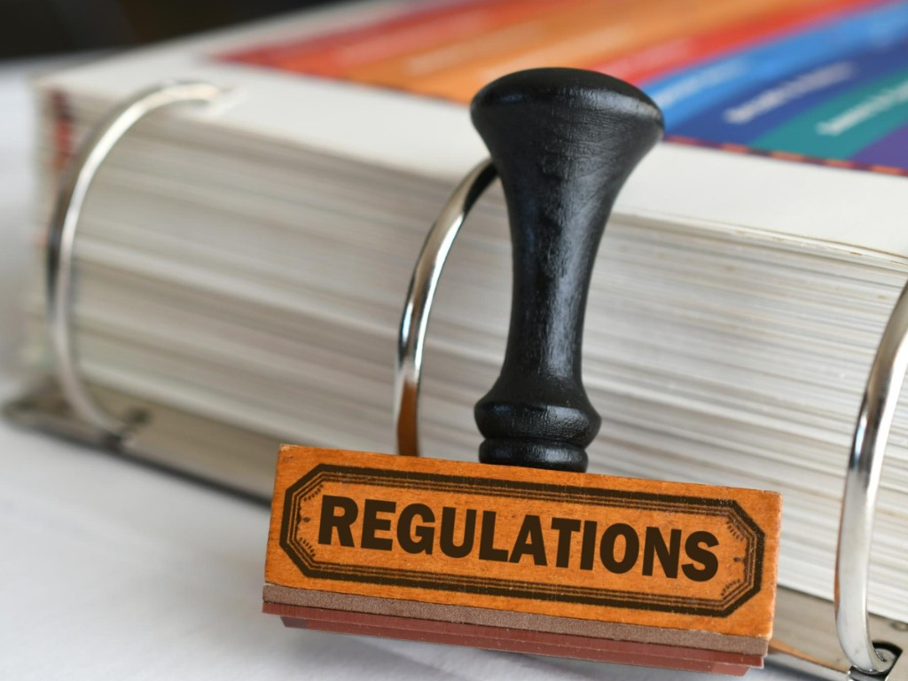 book with wooden handle that says regulations