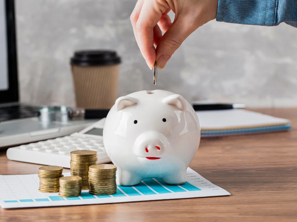 hand putting coin piggy bank growth chart
