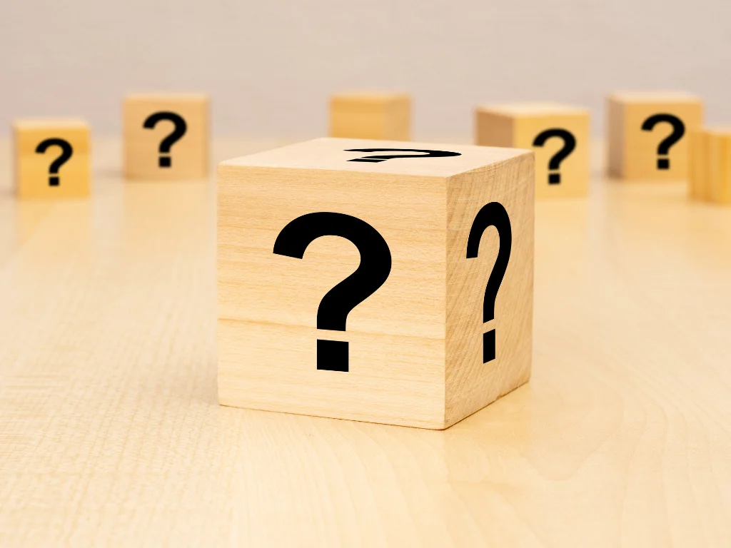 question mark block stand wooden background