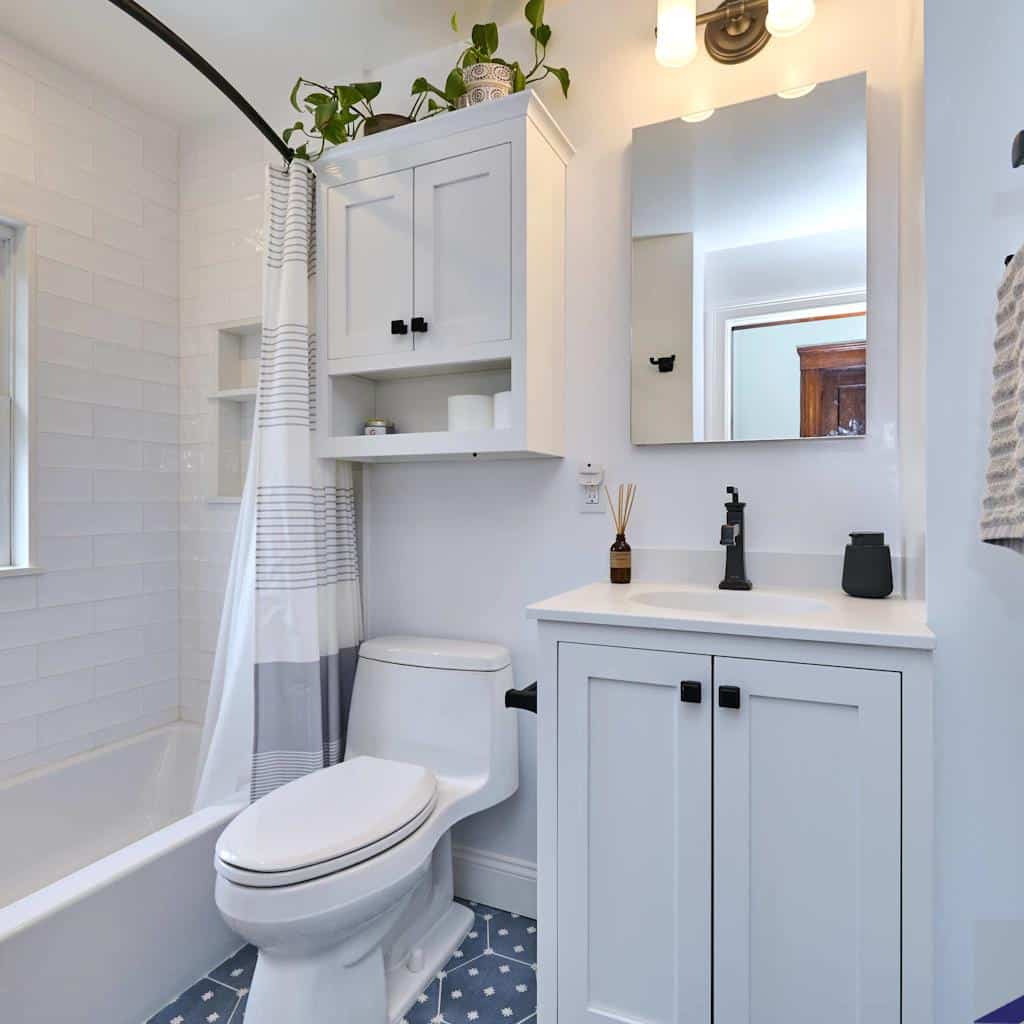 Modernized bathroom with fresh white cabinetry, updated fixtures, and stylish tile flooring after renovation at N. Crescent Circuit.