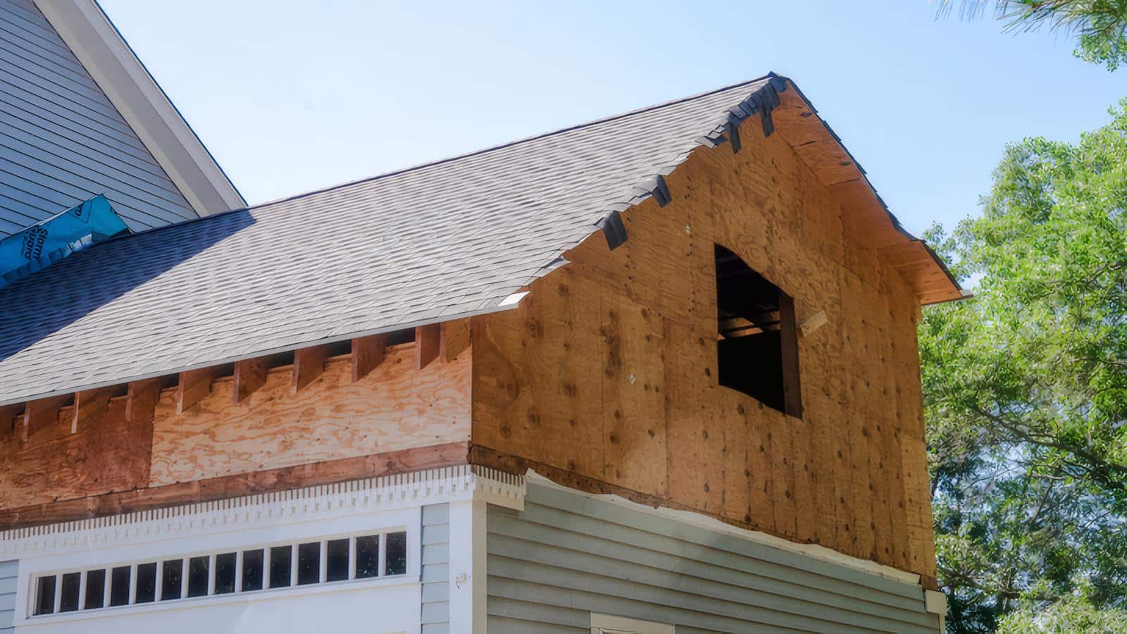 Structural framing and roof work in progress for a second-story addition by Bay State Remodeling in Newton, MA.