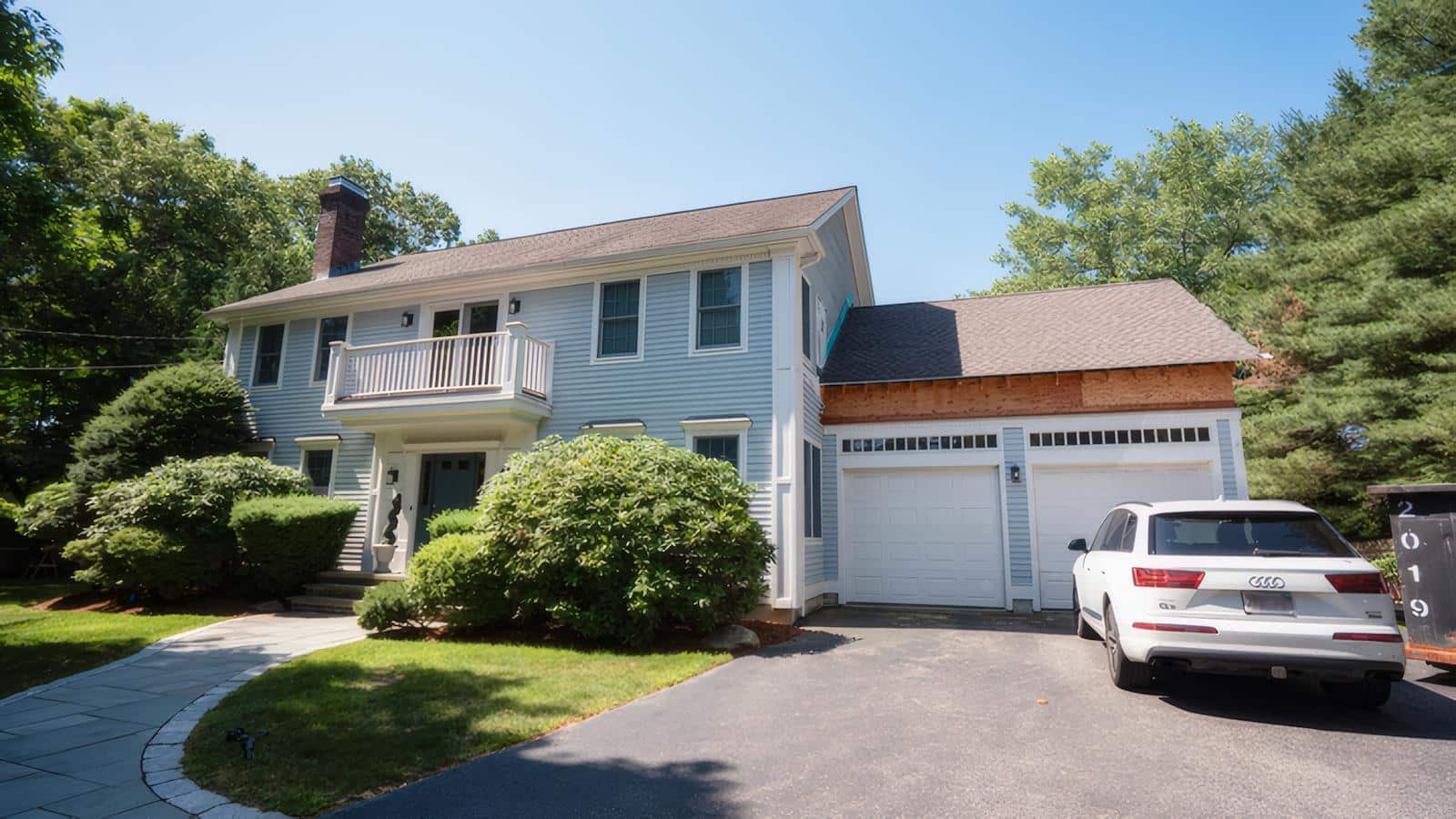 Front view of a Newton, MA home during a second-story addition - transforming family space without moving.