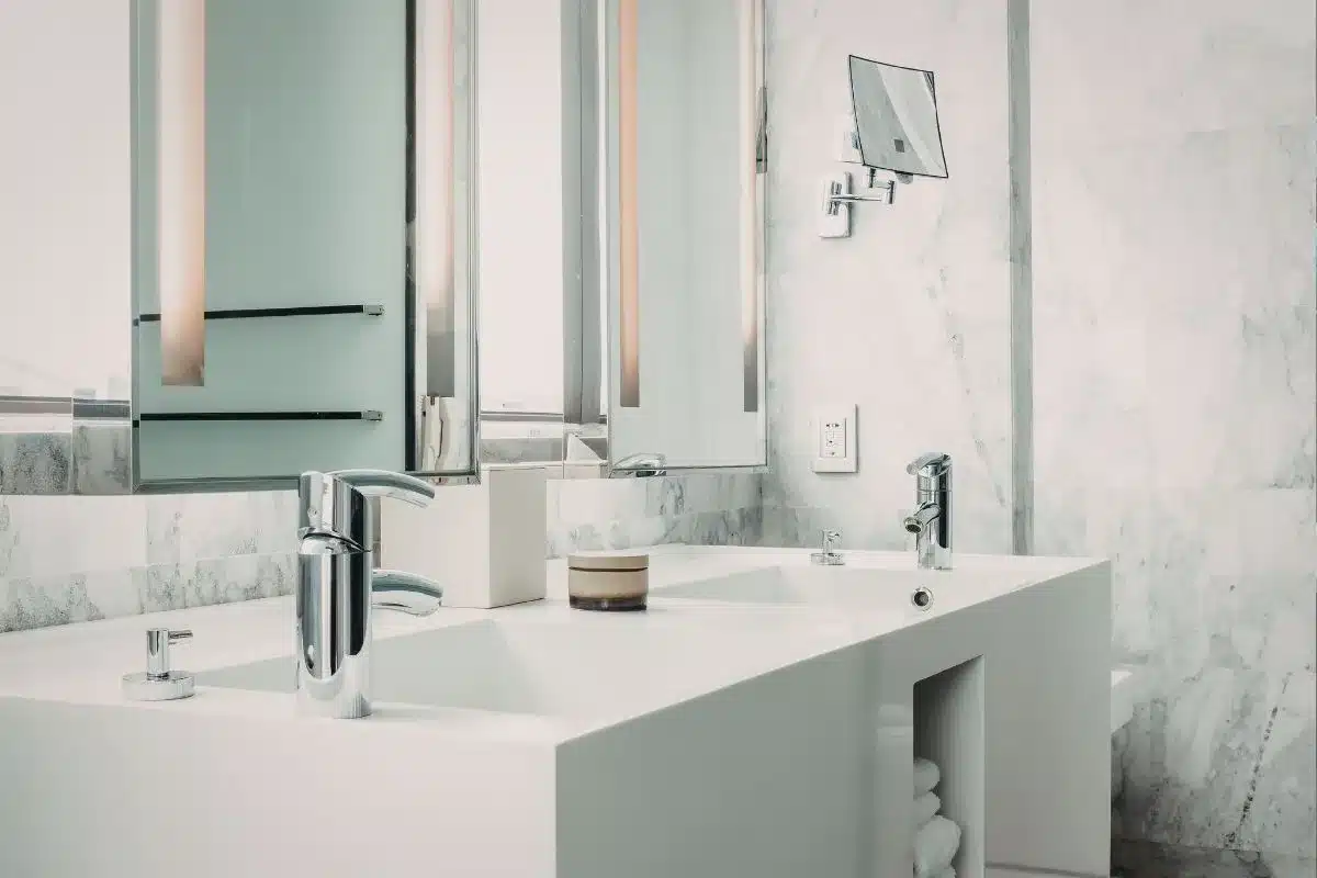 Modern bathroom ideas featuring a double vanity with marble walls and chrome fixtures