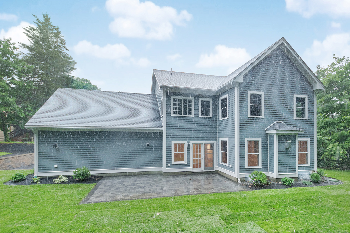 Roof, blue siding and window trim on the completed Garland Road whole-home remodel, which included a second-story addition.