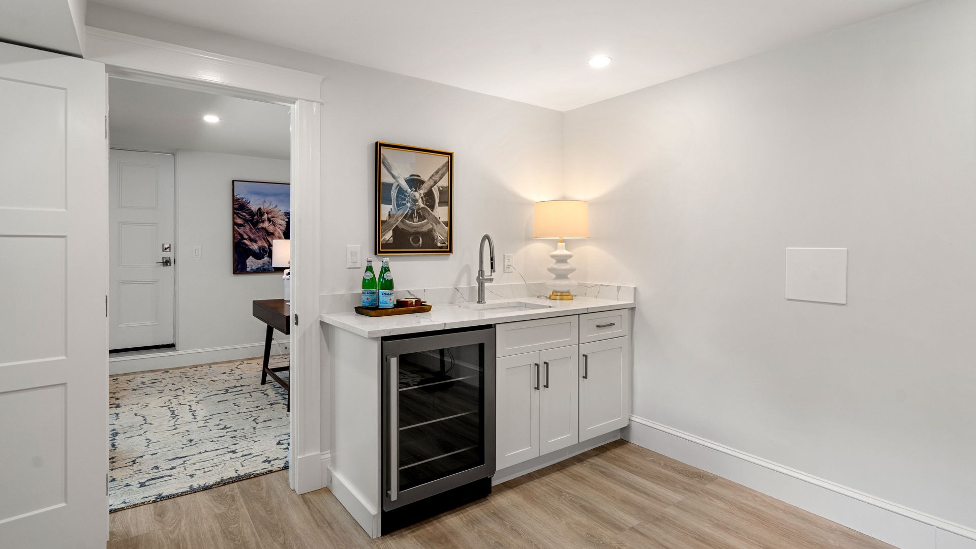 White basement storage cabinets beside a beverage refrigerator at Sewall Street, Newton.